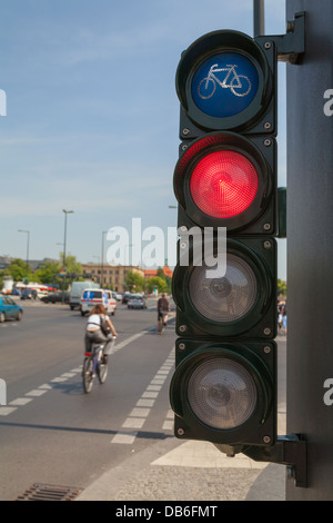 Traffic lights for cyclists; bicycle light turns red, a cyclist cross the street Stock Photo