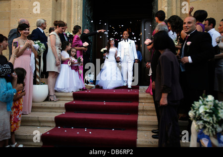 Guests throwing confetti over bride and groom during a Maltese wedding in the city of Citta Victoria also known among the native Maltese as Rabat on the island of Gozo, the sister island of Malta Stock Photo