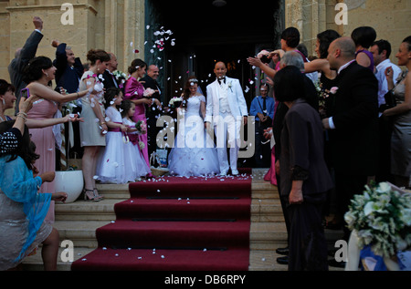 Guests throwing confetti over bride and groom during a Maltese wedding in the city of Citta Victoria also known among the native Maltese as Rabat on the island of Gozo, the sister island of Malta Stock Photo