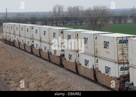 Double stacked swift intermodal containers on BNSF freight train at Wellington KS USA Stock Photo