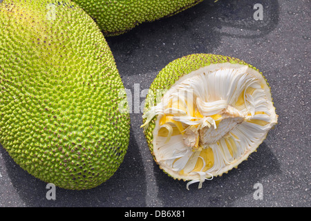 Jackfruit Whole and Open with Yellow Flesh for Sale at Outdoor Wet Market in Southeast Asia Stock Photo