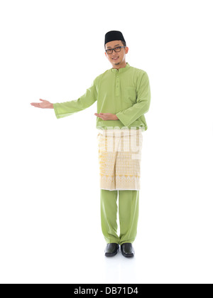 Traditonal Malay man with welcome gesture during ramadan isolated white background Stock Photo