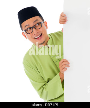 malay male with blank card during hari raya Eid al-Fitr celebration Stock Photo