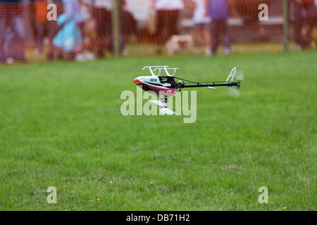 A remote controlled model helicopters carrying out an aerobatic display Stock Photo