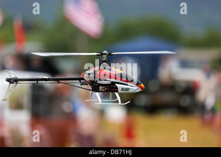A remote controlled model helicopters carrying out an aerobatic display Stock Photo
