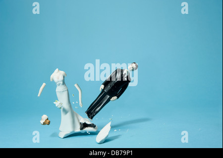 Bride and groom cake topper smashing apart Stock Photo
