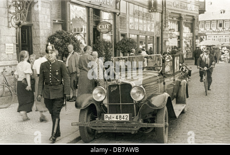 geography / travel,Germany,Wernigerode,street scene,police constable with police car outside of Cafe Hauer,Breitestrasse 4,circa 1930,police constable,patrolman,patrolmen,policeman,police officer,policemen,police officers,grunt,on patrol,police vehicle,convertible,cabriolet,convertibles,cabriolets,8 cylinder,Prussian police uniform,shako,German police,everyday life,daily routine,Harz Mountains,1930s,30s,street,streets,old town,historic city centre,historic city center,Central Europe,Europe,people,city center,town center,c,Additional-Rights-Clearences-Not Available Stock Photo