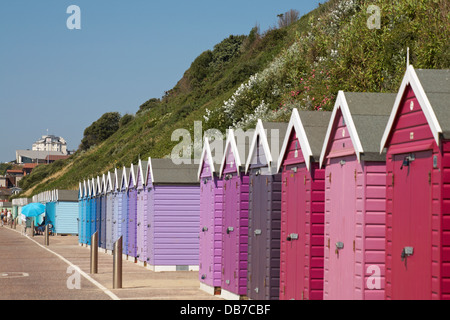 Shades of  purple, mauve and blue beach huts at Boscombe Bournemouth on sunny day in July Stock Photo