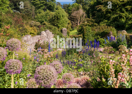 Kingswear, Devon, England. July 9th 2013. A garden scene with the sea in the distance through the trees. Stock Photo