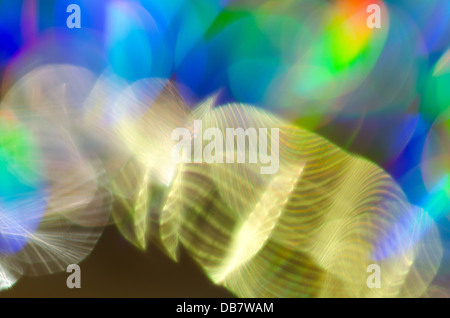 light interference patterns prismatic colors and banding almost snake like in abstract array of circular c=shapes Stock Photo