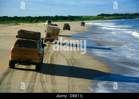 Leisure - 4x4 driving offroad driving adventure convoy 4x4 vehicles drive along beach in Angola near sea beach driving on sand Stock Photo