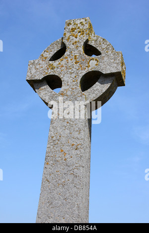 Stone Celtic Cross Of The Llanddwyn Island War Memorial Set Against Blue Sky Stock Photo