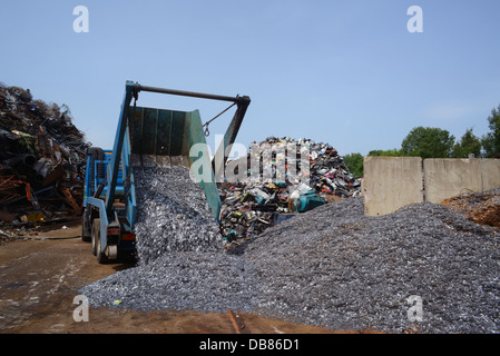 lorry emptying skip load of scrap metal for processing at scrapyard united kingdom Stock Photo