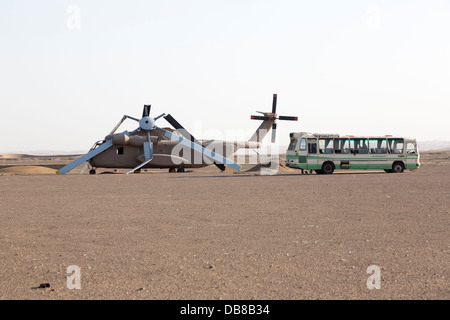 American services Operation Eagle Claw abandoned and wrecked helicopter and Iranian bus, Tabas, Iran Stock Photo