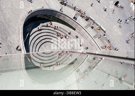 London, UK - 25 July 2013: People enjoy the sun at the Scoop amphitheather as heatwave continues to hit the UK Credit:  Piero Cruciatti/Alamy Live News Stock Photo