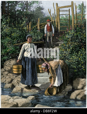 Women drawing water, Cape Breton Island, Canada, 1880s. Hand-colored woodcut of an A.B. Frost illustration Stock Photo