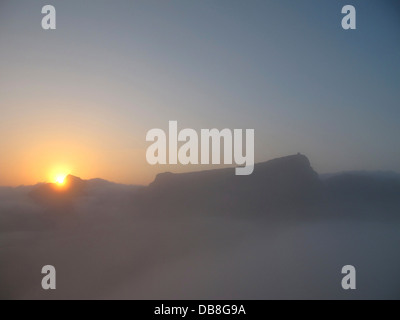sunrise through the mist over Devils Peak and Table Mountain, Cape Town