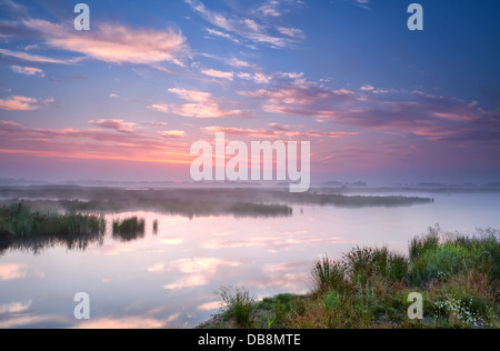 warm summer sunrise over river, Groningen, Netherlands Stock Photo