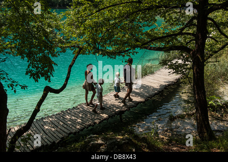 A family walks on a path on July 25, 2006 in Plitvice Lakes National Park, Croatia. Stock Photo