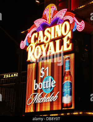 Night portrait electronic billboard '$1 bottle Budlight' below yellow pink neon sign, Casino Royale, The Strip, Las Vegas, USA Stock Photo