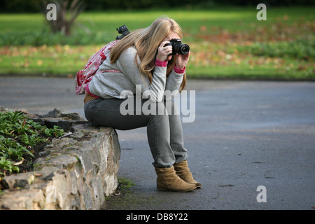 female photographer using a camera Stock Photo