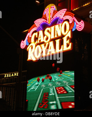 Night view electric billboard red tumbling dice green craps table below yellow pink neon sign, Casino Royale, Las Vegas Strip Stock Photo