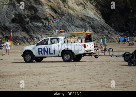 NEWQUAY, CORNWALL, ENGLAND, UK. JULY 25th 2013.  The Royal National Lifeboat Institution working on Towan Beach on July 25, 2012. The RNLI rescued 15 people on this day alone from Porth Beach. Credit:  Nicholas Burningham/Alamy Live News Stock Photo