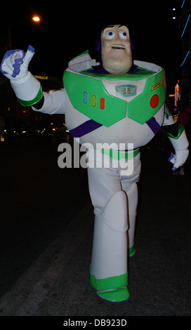 Night flashlight portrait street entertainer dressed as Buzz Lightyear, posing dark sidewalk, O'Shea's Casino, Las Vegas Strip Stock Photo