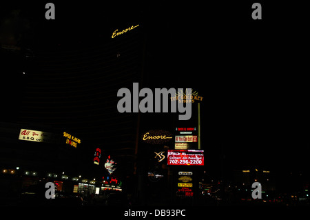 Night view, to Encore and Treasure Island Resorts, neon road sign and shop advertisement signs, Gold Key Shops, Las Vegas Strip Stock Photo