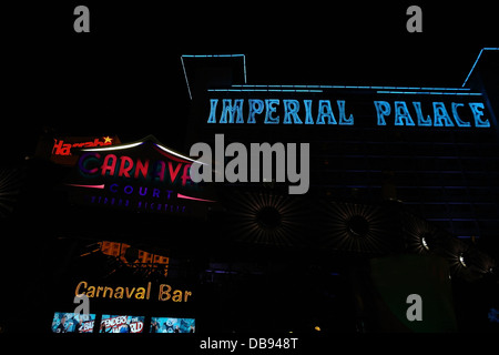 Night neon view yellow Carnaval Bar, red Carnaval Court signs, in front of blue neon Imperial Palace tower, Las Vegas Strip, USA Stock Photo