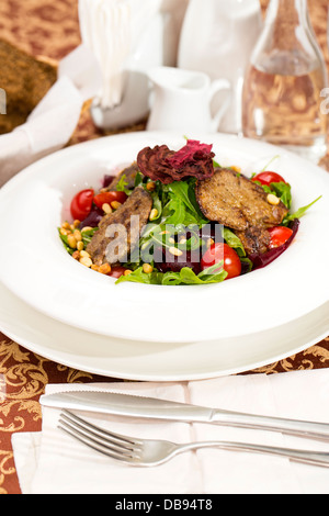 rabbit liver salad with arugula in a restaurant Stock Photo