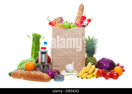 A paper bag full of groceries, surrounded by fruits, vegetables, bread, bottled beverages, and canned goods. Studio isolated. Stock Photo