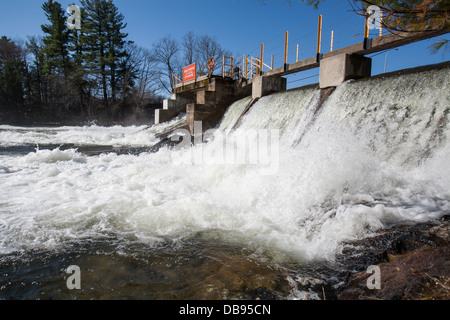 Water falls over the Norland Dam in the spring. Stock Photo