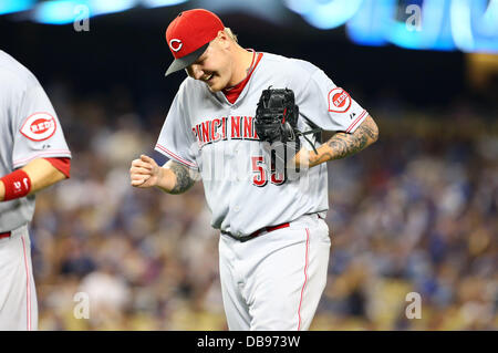 Cincinnati Reds pitcher Mat Latos shows his tattoos as he poses for a  picture during the team's photo day before spring training baseball  workouts Thursday, Feb. 20, 2014, in Goodyear, Ariz. (AP