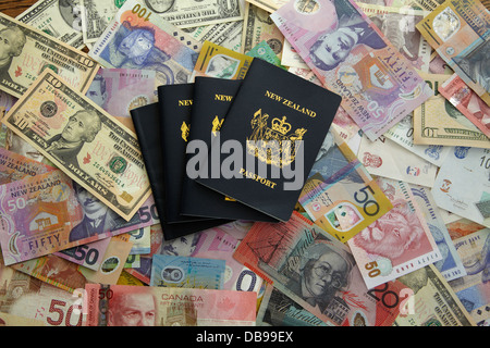 New Zealand passports and foreign currency - Australian, Canadian, US and New Zealand dollars, and South African rand Stock Photo