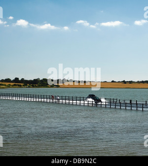 The Strood Causeway. The only road connecting Island of Mersea to the mainland which is flooding during a spring tide. Stock Photo