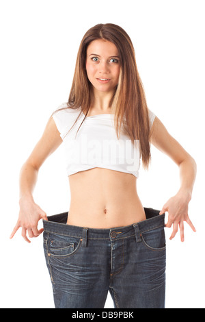 Young woman looking surprised showing how much weight she lost, isolated on white Stock Photo