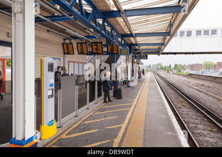 Passengers waiting for a train on railway platform. Stock Photo