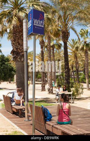 WiFi hotspot area sign on beach under palm trees. Stock Photo