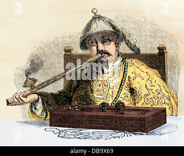 Opium pipe smoked in China, 1850s. Hand-colored woodcut Stock Photo