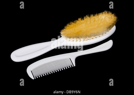 Two white hairbrushes on black background Stock Photo
