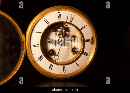 showing the face and dial of an old antique british victorian clock Stock Photo