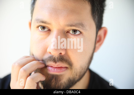 thirty-something man has an irritation in his beard Stock Photo