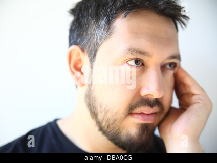 bearded thirty-something man with a pensive expression Stock Photo