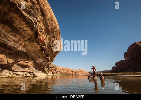 Lisa Hathaway bouldering at Goldbar bouldering area on the Colorado river near Moab, Utah. Stock Photo