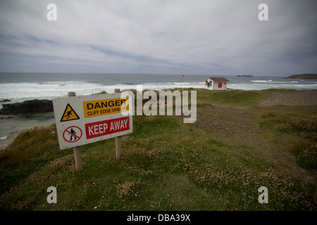 Gwithian coastline Cornwall, with danger cliff edge unsafe keep away sign Stock Photo