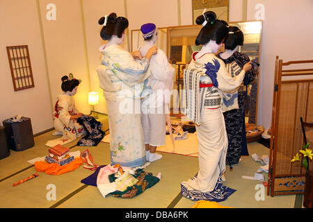 London, UK. 26th July 2013. Geishas dressing for their performance at the Yanaka Geisha House run by Sayuki, the first white Geisha at the Hyper Japan Japanese Culture Festival Credit:  Paul Brown/Alamy Live News Stock Photo