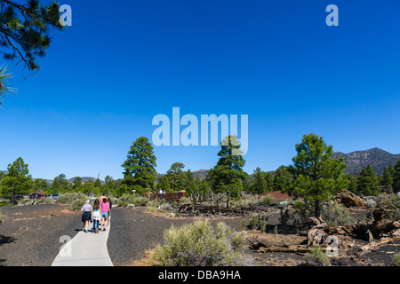 Tourists on the Lava Flow Trail at Sunset Crater Volcano National Monument, near Flagstaff, Arizona, USA Stock Photo