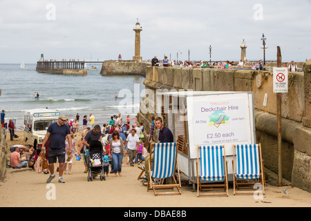 A man hiring deckchairs near the beach in Whitby, Yorkshire Stock Photo
