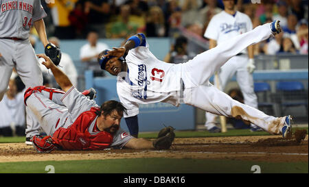 Los Angeles, California, USA. 26th July, 2013. Los Angeles Dodgers shortstop HANLEY RAMIREZ (right) crosses home plate but is tagged out by Cincinnati Reds catcher CORKY MILLER (left) after missing the plate during the Major League Baseball game between the Cincinnati Reds and the Los Angeles Dodgers at Dodger Stadium. Credit:  csm/Alamy Live News Stock Photo